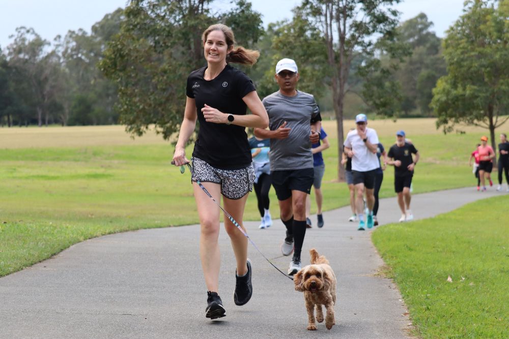 Woman running with dog